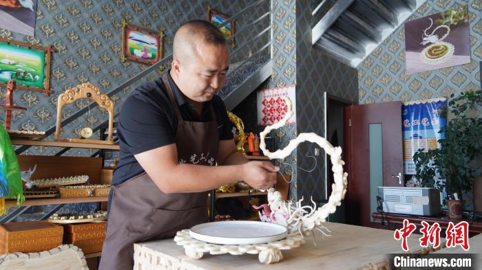 图为刘金才与他最爱的作品《腾龙盘》。　刘金才供图